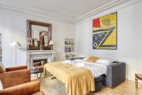 a bedroom with a bed and a fireplace at Gorgeous and large flat in the heart of Paris 09 in Paris