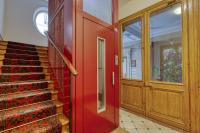 a red door and stairs with a christmas tree at Gorgeous and large flat in the heart of Paris 09 in Paris