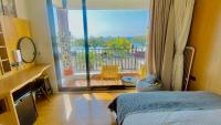 a bedroom with a bed and a large window at Mini Summer in Nanwan