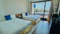 a hotel room with two beds and a balcony at Mini Summer in Nanwan