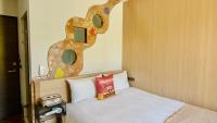 a bedroom with a bed with a book on it at Mini Summer in Nanwan