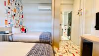 a hotel room with two beds and a mirror at Mini Summer in Nanwan