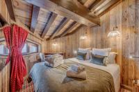 a bedroom with a bed in a wooden cabin at HOTEL LE VAL D&#39;ISERE in Val-d&#39;Isère