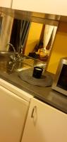 a kitchen counter with a sink with a cup on it at RELAX in Montreuil