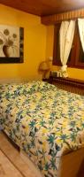 a bedroom with a bed with a blue and yellow comforter at RELAX in Montreuil
