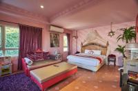 a bedroom with a bed and a couch at Sharjah B&amp;B in Wujie