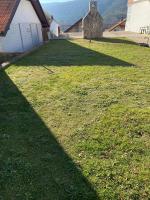 a shadow of a house on a grassy yard at Apartment Angelina 