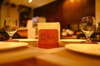 two wine glasses and a napkin holder on a table at ISORA RESORT Puerto Galera in Puerto Galera