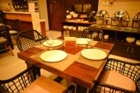 a wooden table with empty plates and wine glasses at ISORA RESORT Puerto Galera in Puerto Galera