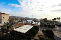 a view of a marina from a balcony with a bus at Pavillon de Mer YourHostHelper in Vallauris