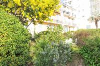 a garden with flowers in front of a building at Pavillon de Mer YourHostHelper in Vallauris