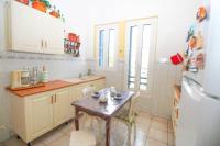a kitchen with a small table and a refrigerator at Pavillon de Mer YourHostHelper in Vallauris