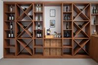 a wine cellar with wooden shelves and wine bottles at Villa Roca in Privlaka