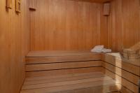a sauna with a wooden floor and a wooden shelf at Villa Roca in Privlaka