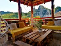 a porch with two beds and a table and chairs at Konak Jerma in Pirot