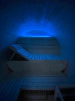 a blue light on a bench in a room at Au-Doux-Altic chalet romantique avec JACUZZI ET SAUNA in Métabief