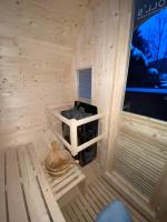 a small wooden cabin with a bench in it at Au-Doux-Altic chalet romantique avec JACUZZI ET SAUNA in Métabief