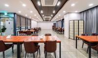 a dining room with wooden tables and chairs at Golden Tulip Essential Namgang in Jinju