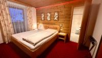a small bedroom with a bed and a bathroom at Pension Schierl in Faistenau