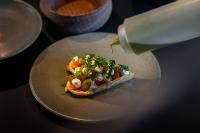 a plate with a piece of pizza on a table at Hotel Akureyri in Akureyri
