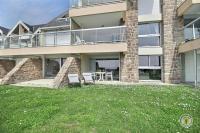 a house with a lawn in front of it at La plage in Trébeurden