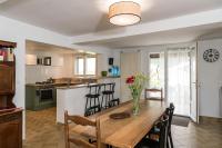 a kitchen and dining room with a table and chairs at le Guydine 