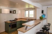 a kitchen with green cabinets and a wooden counter top at le Guydine 