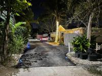 a street at night with a car parked on the road at Sandelwood Studios&#39; in Nassau