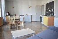 a kitchen and living room with a table and a couch at Résidence Le Rochebonne in Saint Malo
