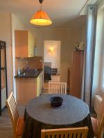 a kitchen and a table with a bowl on it at Résidence Le Rochebonne in Saint Malo