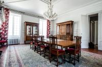 a dining room with a wooden table and chairs at Gîte Château de Seguin in Lignan-de-Bordeaux