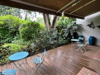 a patio with chairs and tables on a deck at Green Elephant in Lilongwe