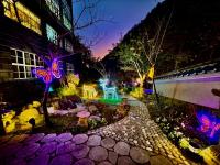 a garden lit up at night with lights at Uni-Resort Ku-Kuan in Heping