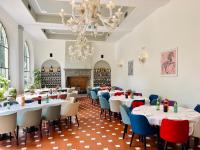 a dining room with tables and chairs and a chandelier at Fantastic Garden - Firenze Nord in Sesto Fiorentino