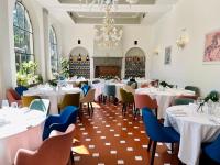a dining room with tables and chairs and a chandelier at Fantastic Garden - Firenze Nord in Sesto Fiorentino
