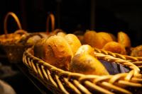 a basket filled with lots of different types of bread at Hotel Bavaria Brehna in Brehna