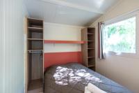 a small bedroom with a bed and a window at Domaine La Pinède Enchantée in Argelès-sur-Mer