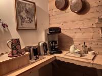 a kitchen counter with a coffee maker and a coffeemaker at Les Chemins du Léman in Novel