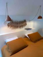 a bedroom with a bed and a shelf with a feather on it at La maison Léopoldine 