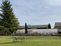 a picnic table in a field with a train in the background at La maison Léopoldine 