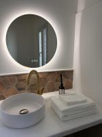 a bathroom with a white sink and a mirror at La maison Léopoldine 