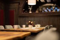 Una mesa en un restaurante con tazas y flores encima. en Haller's Posthotel, en Riezlern