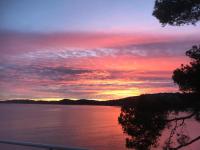 a sunset over a large body of water at Bel appartement hyper centre, direct plage. in Sainte-Maxime