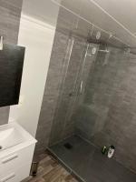 a bathroom with a shower with a glass door at Appartement Souplex, Cholet in Cholet