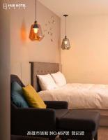 a bedroom with a bed and a couch and lights at Hub Hotel Kaohsiung Yawan Branch in Kaohsiung