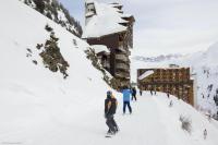 a group of people skiing in the snow in front of a building at Résidence Antarès - Avoriaz in Avoriaz