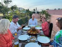 a group of people sitting around a table eating at Riad Atrium & Spa in Marrakech
