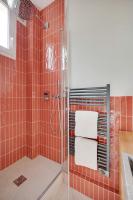 a bathroom with a shower with red tile at Comfy Suite by Les Maisons de Charloc Homes in Boulogne-Billancourt
