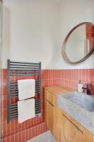 a bathroom with a sink and a mirror and towels at Comfy Suite by Les Maisons de Charloc Homes in Boulogne-Billancourt