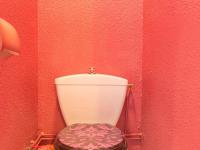 a bathroom with a toilet in a red wall at Studio Le Corbier, 1 pièce, 5 personnes - FR-1-267-232 in Villarembert